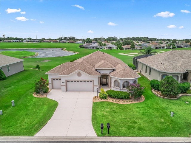 12198 SE 176th Loop, Summerfield, FL 34491 - view of front of home with an attached garage, a residential view, driveway, a front lawn, and stucco siding