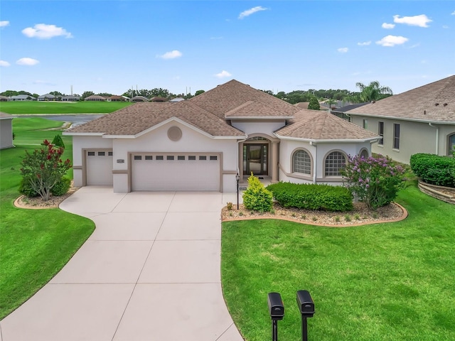 12198 SE 176th Loop, Summerfield, FL 34491 - mediterranean / spanish home with a garage, a front lawn, concrete driveway, stucco siding, and a shingled roof