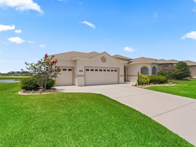 12198 SE 176th Loop, Summerfield, FL 34491 - mediterranean / spanish house with a garage, stucco siding, a front yard, and driveway