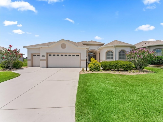 12198 SE 176th Loop, Summerfield, FL 34491 - mediterranean / spanish-style home with stucco siding, a garage, driveway, and a front yard