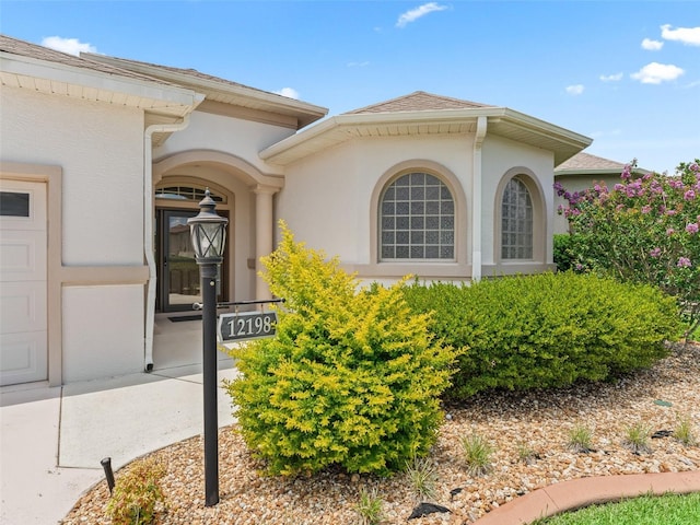 12198 SE 176th Loop, Summerfield, FL 34491 - entrance to property featuring stucco siding and a shingled roof
