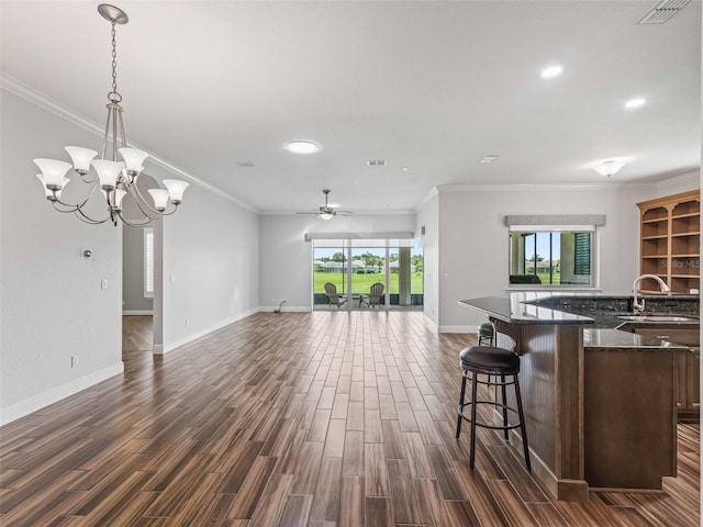 12198 SE 176th Loop, Summerfield, FL 34491 - kitchen with open floor plan, dark wood-style floors, a breakfast bar area, recessed lighting, and a ceiling fan