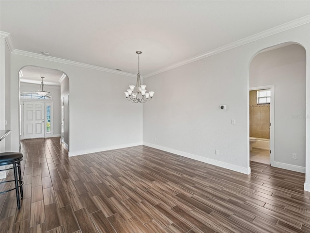 12198 SE 176th Loop, Summerfield, FL 34491 - empty room featuring arched walkways, dark wood finished floors, crown molding, and a chandelier