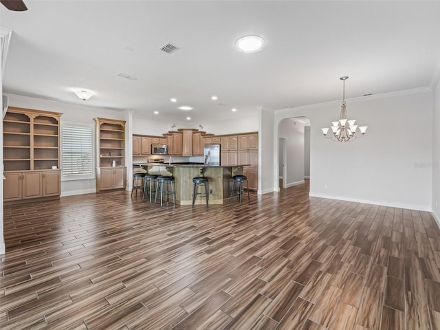 12198 SE 176th Loop, Summerfield, FL 34491 - unfurnished living room with arched walkways, dark wood-type flooring, a chandelier, recessed lighting, and crown molding