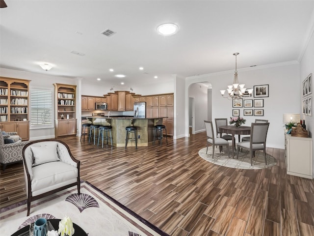 12198 SE 176th Loop, Summerfield, FL 34491 - living room featuring arched walkways, dark wood finished floors, recessed lighting, a chandelier, and ornamental molding