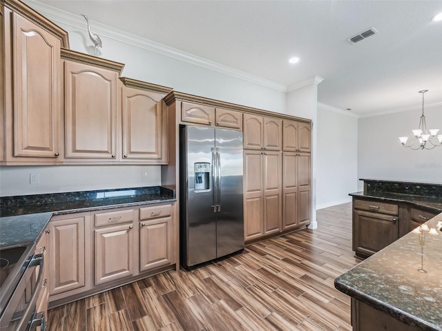 12198 SE 176th Loop, Summerfield, FL 34491 - kitchen with stainless steel fridge with ice dispenser, a chandelier, ornamental molding, dark wood finished floors, and dark stone countertops