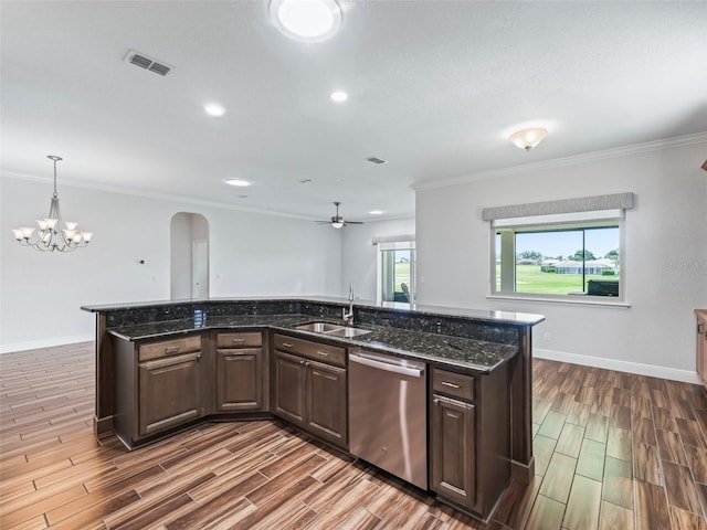 12198 SE 176th Loop, Summerfield, FL 34491 - kitchen with dishwasher, wood finish floors, arched walkways, dark brown cabinetry, and crown molding