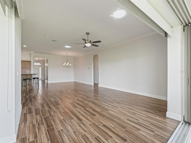12198 SE 176th Loop, Summerfield, FL 34491 - unfurnished living room with arched walkways, a chandelier, a ceiling fan, dark wood-type flooring, and ornamental molding