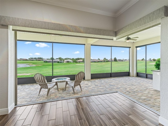 12198 SE 176th Loop, Summerfield, FL 34491 - sunroom with golf course view, an outdoor fire pit, ceiling fan, and a residential view
