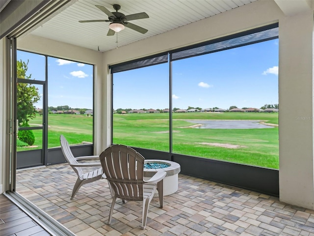 12198 SE 176th Loop, Summerfield, FL 34491 - sunroom / solarium featuring view of golf course, a ceiling fan, and an outdoor fire pit