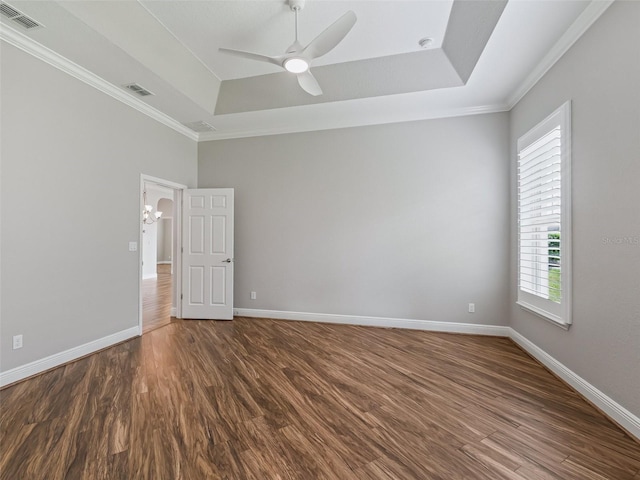 12198 SE 176th Loop, Summerfield, FL 34491 - empty room with a tray ceiling, healthy amount of natural light, a ceiling fan, ornamental molding, and dark wood-style floors