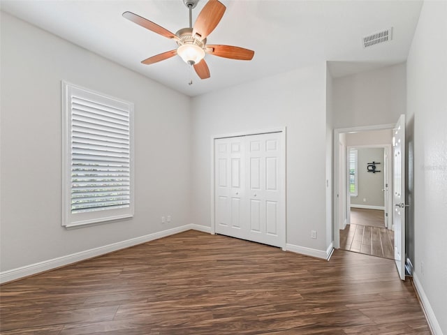 12198 SE 176th Loop, Summerfield, FL 34491 - unfurnished bedroom with dark wood-style floors, a closet, and a ceiling fan