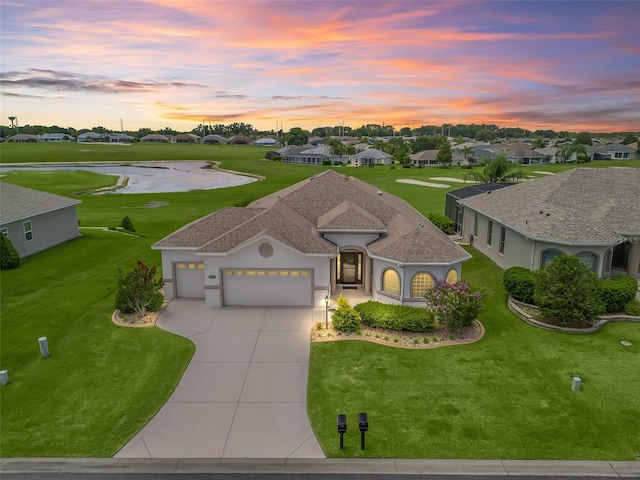 12198 SE 176th Loop, Summerfield, FL 34491 - mediterranean / spanish-style house with an attached garage, driveway, a lawn, stucco siding, and a water view