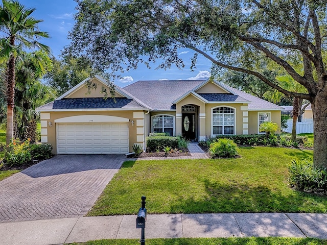 359 Blue Branch St, Eustis, FL 32736 - single story home with stucco siding, a garage, decorative driveway, a front yard, and a shingled roof
