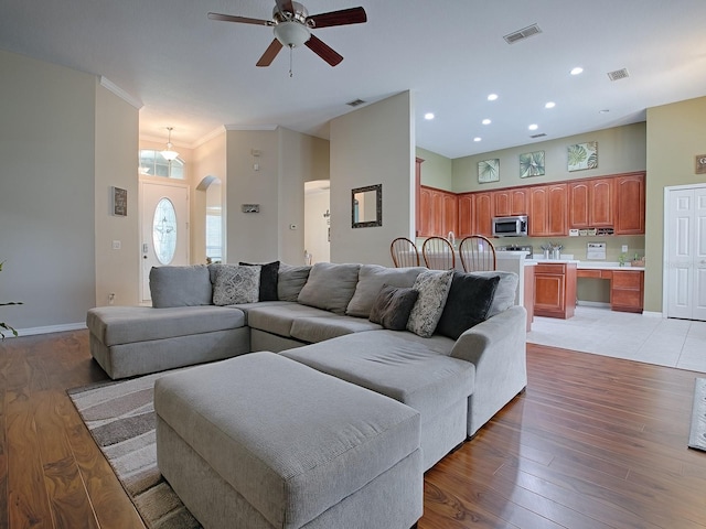359 Blue Branch St, Eustis, FL 32736 - living area with ceiling fan, light wood-style flooring, arched walkways, a towering ceiling, and recessed lighting