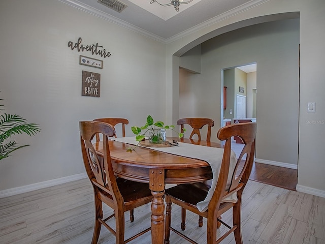 359 Blue Branch St, Eustis, FL 32736 - dining space with arched walkways, light wood-style flooring, and crown molding