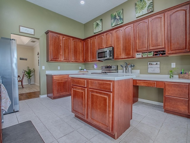 359 Blue Branch St, Eustis, FL 32736 - kitchen with stainless steel appliances, light countertops, light tile patterned flooring, built in study area, and a kitchen island