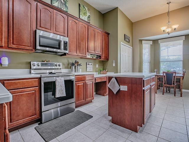 359 Blue Branch St, Eustis, FL 32736 - kitchen with appliances with stainless steel finishes, light countertops, light tile patterned floors, a kitchen island, and a chandelier