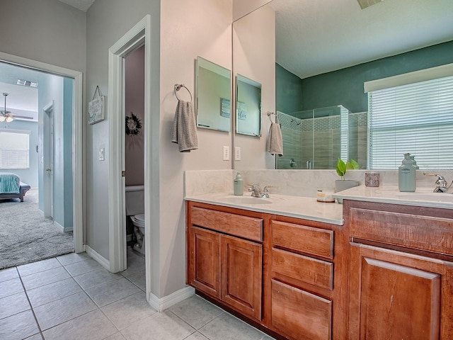 359 Blue Branch St, Eustis, FL 32736 - ensuite bathroom featuring a stall shower, double vanity, tile patterned flooring, and ceiling fan
