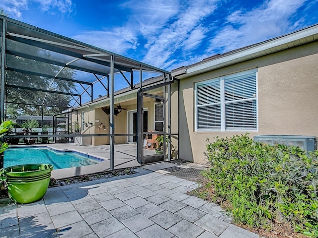 359 Blue Branch St, Eustis, FL 32736 - view of patio featuring ceiling fan, glass enclosure, and an outdoor pool