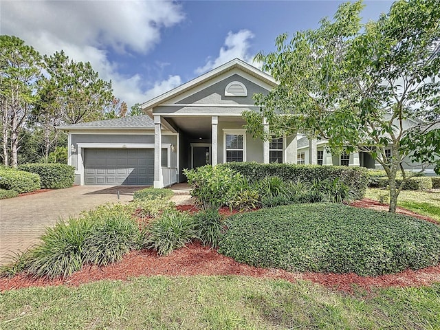 101 Flame Vine Way, Groveland, FL 34736 - view of front facade with stucco siding, an attached garage, and driveway