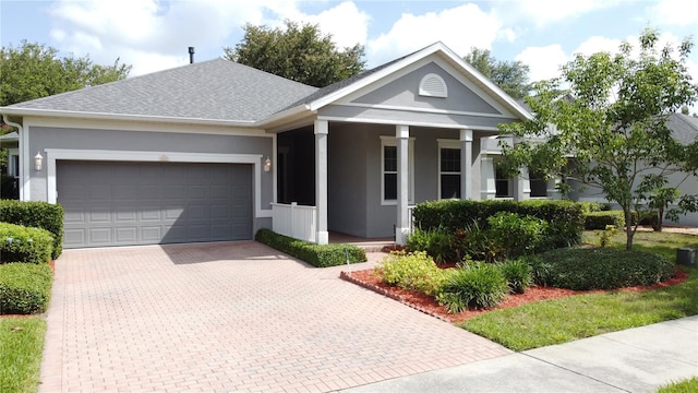 101 Flame Vine Way, Groveland, FL 34736 - view of front facade with covered porch, decorative driveway, an attached garage, and stucco siding