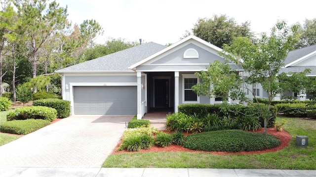 101 Flame Vine Way, Groveland, FL 34736 - view of front of house featuring a garage, driveway, and stucco siding