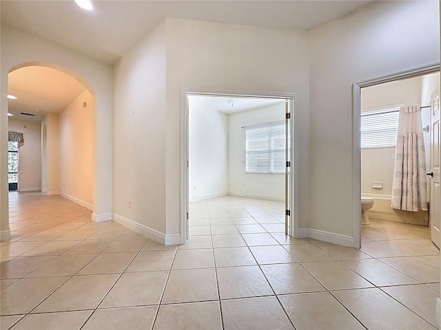 101 Flame Vine Way, Groveland, FL 34736 - empty room featuring arched walkways, light tile patterned floors, plenty of natural light, and recessed lighting