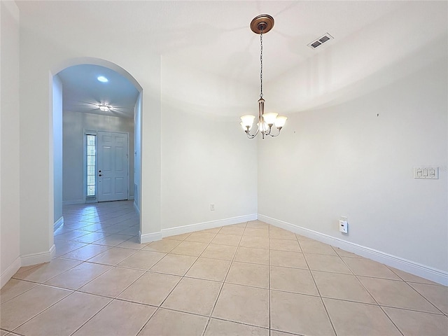 101 Flame Vine Way, Groveland, FL 34736 - spare room featuring light tile patterned floors, arched walkways, and a chandelier
