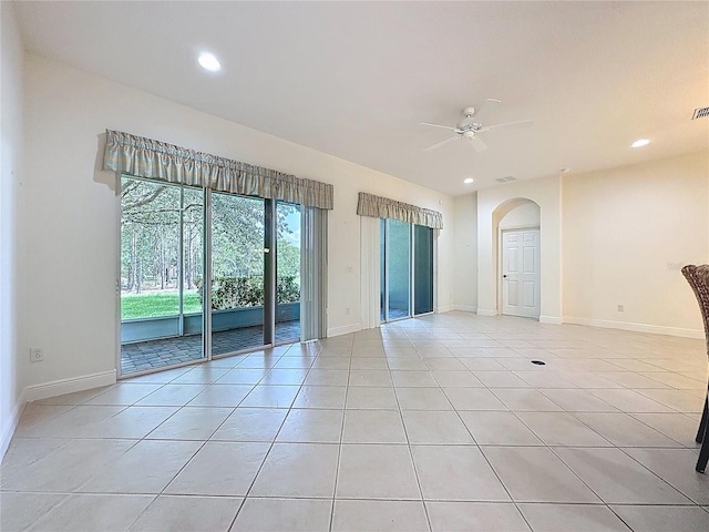 101 Flame Vine Way, Groveland, FL 34736 - empty room featuring light tile patterned flooring, ceiling fan, recessed lighting, and arched walkways