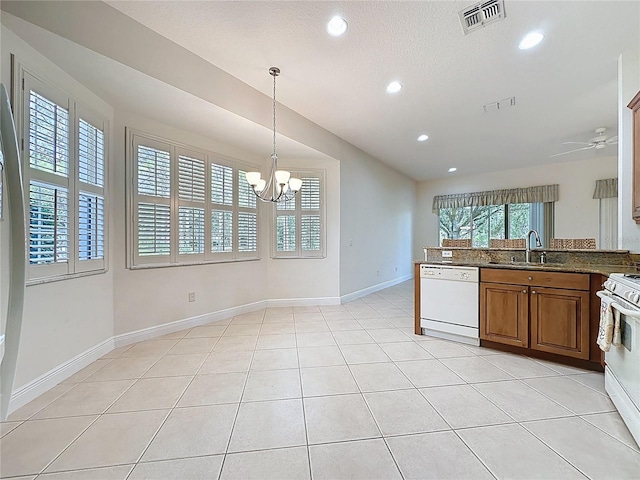 101 Flame Vine Way, Groveland, FL 34736 - kitchen featuring white appliances, brown cabinetry, a chandelier, recessed lighting, and decorative light fixtures
