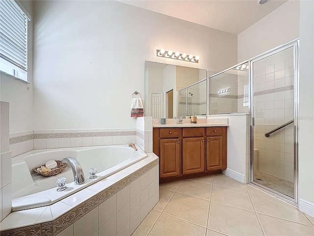 101 Flame Vine Way, Groveland, FL 34736 - bathroom with a bath, a stall shower, vanity, and tile patterned floors
