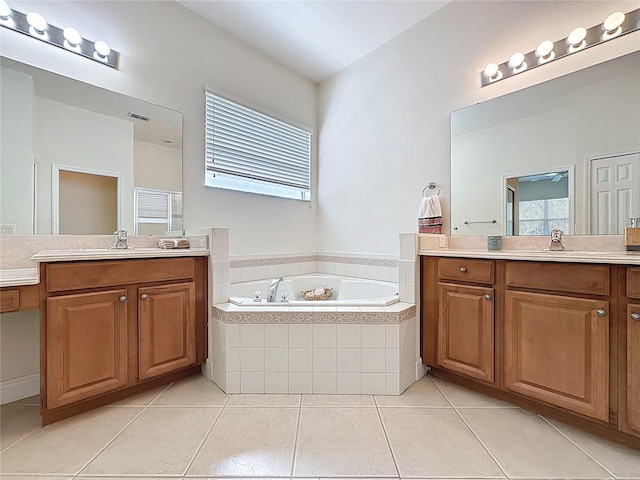 101 Flame Vine Way, Groveland, FL 34736 - full bath with two vanities, a garden tub, and tile patterned flooring