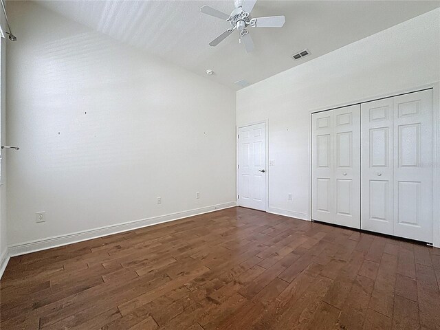 101 Flame Vine Way, Groveland, FL 34736 - unfurnished bedroom featuring dark wood-type flooring, high vaulted ceiling, and ceiling fan