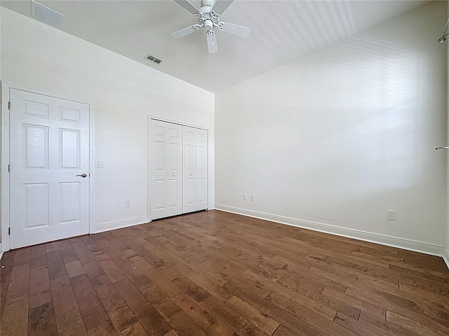 101 Flame Vine Way, Groveland, FL 34736 - unfurnished bedroom with dark wood-type flooring, lofted ceiling, a closet, and a ceiling fan