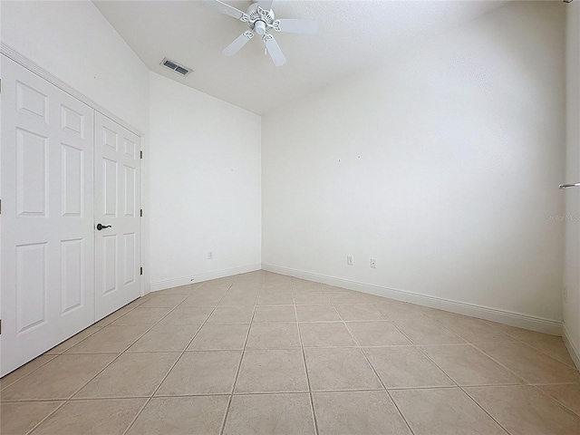 101 Flame Vine Way, Groveland, FL 34736 - unfurnished bedroom with lofted ceiling, light tile patterned flooring, and ceiling fan