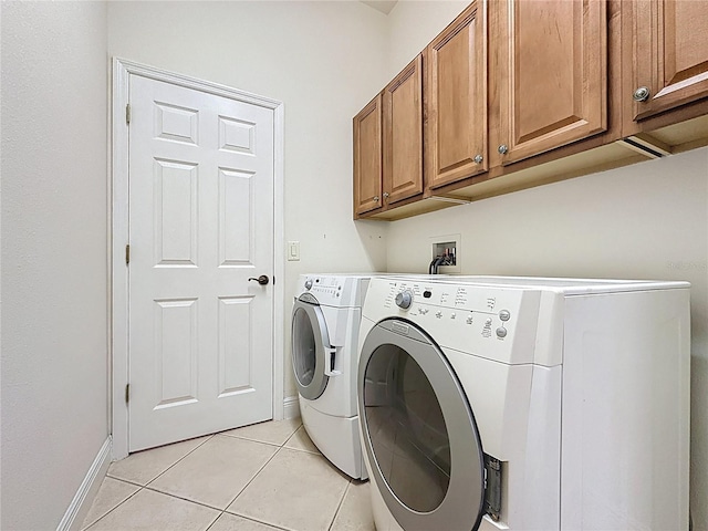 101 Flame Vine Way, Groveland, FL 34736 - laundry area featuring cabinet space, washing machine and clothes dryer, and light tile patterned floors