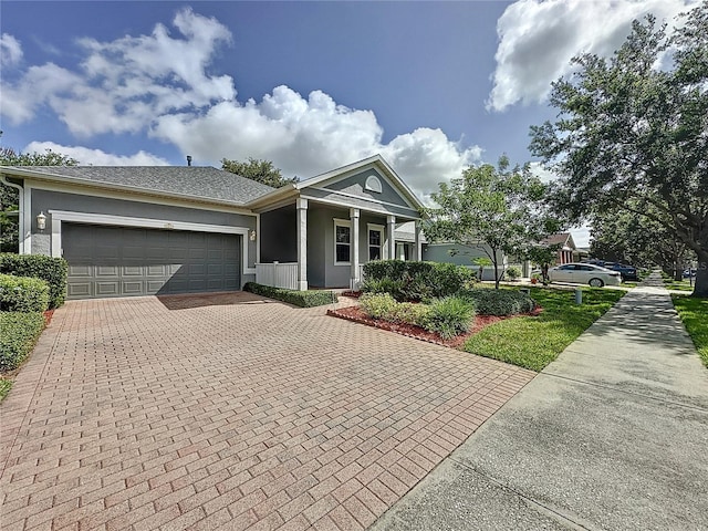 101 Flame Vine Way, Groveland, FL 34736 - view of front facade featuring decorative driveway, stucco siding, and a garage
