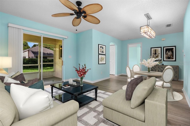 3586 Eversholt St, Clermont, FL 34711 - living room featuring wood finished floors, ceiling fan, and arched walkways