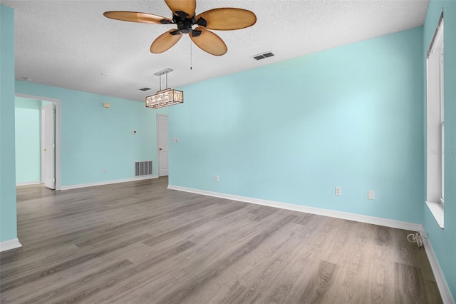 3586 Eversholt St, Clermont, FL 34711 - spare room with a textured ceiling, ceiling fan, and wood finished floors