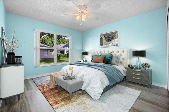 3586 Eversholt St, Clermont, FL 34711 - bedroom featuring wood finished floors, a textured ceiling, and a ceiling fan