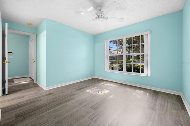 3586 Eversholt St, Clermont, FL 34711 - unfurnished room with wood finished floors, a textured ceiling, and ceiling fan