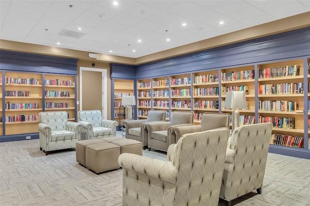 3586 Eversholt St, Clermont, FL 34711 - living area with wall of books, carpet floors, and a drop ceiling