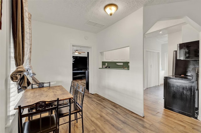 520 Dora Ave, Tavares, FL 32778 - kitchen with white cabinetry, a textured ceiling, light wood finished floors, and a ceiling fan