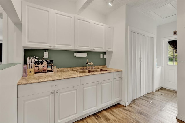 520 Dora Ave, Tavares, FL 32778 - kitchen featuring white cabinetry and light wood-style flooring