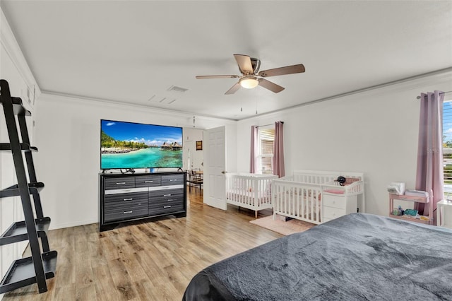520 Dora Ave, Tavares, FL 32778 - bedroom with light wood-type flooring, ornamental molding, multiple windows, and ceiling fan