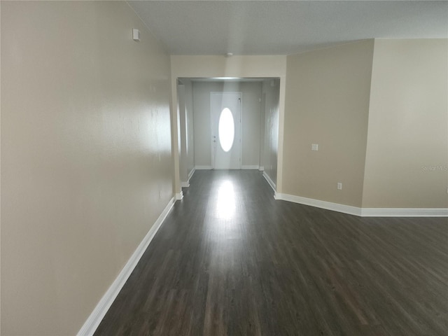 222 Bacopa Pass, Davenport, FL 33897 - spare room featuring dark wood finished floors and baseboards