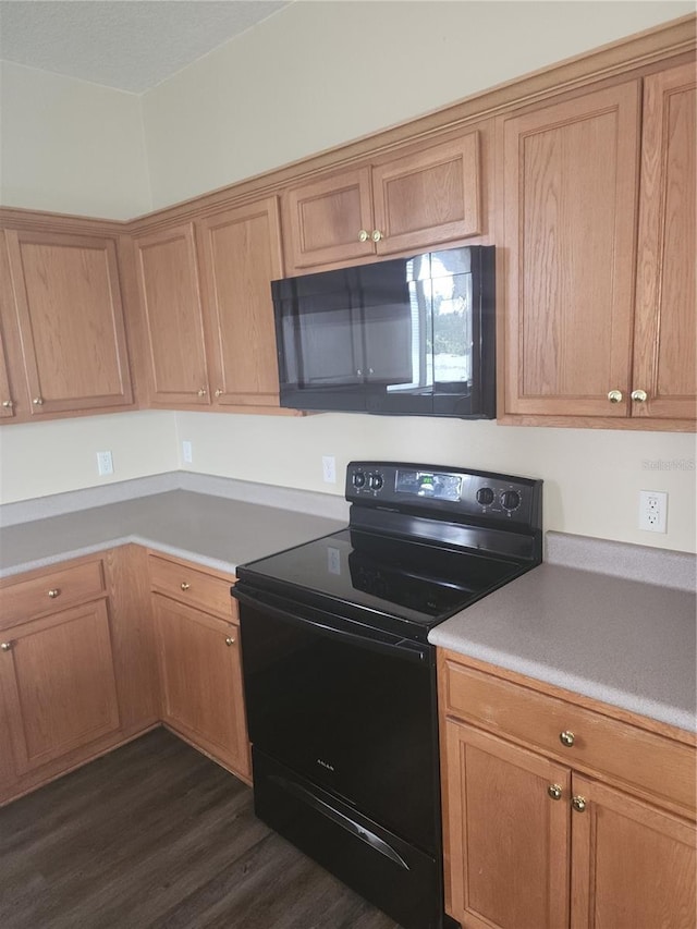 222 Bacopa Pass, Davenport, FL 33897 - kitchen featuring black appliances, dark wood-type flooring, and light countertops