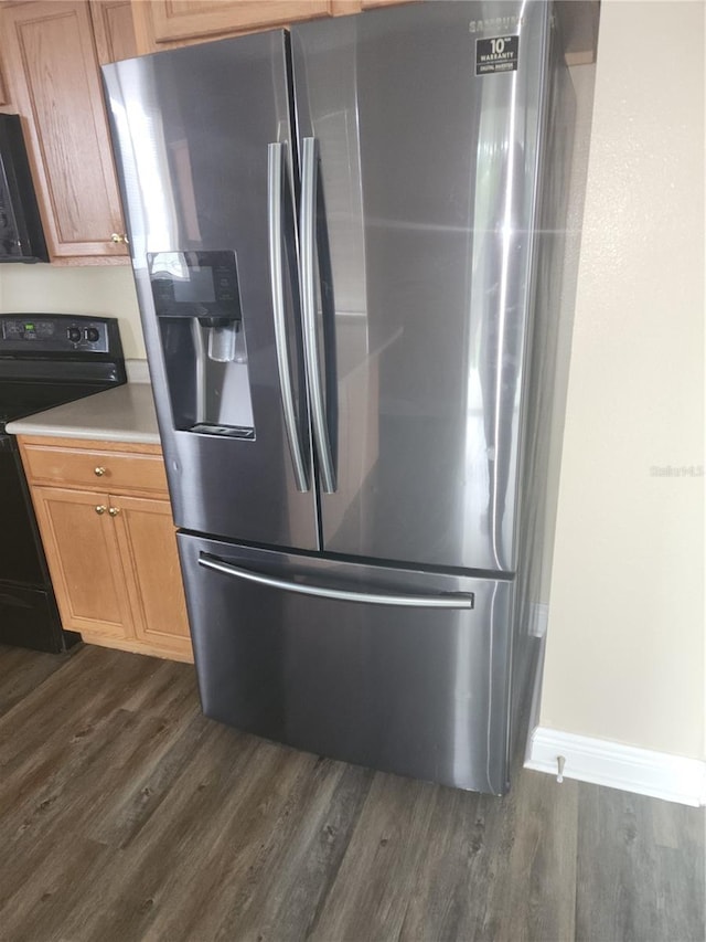 222 Bacopa Pass, Davenport, FL 33897 - kitchen with stainless steel fridge with ice dispenser, black electric range oven, dark wood-type flooring, and light countertops