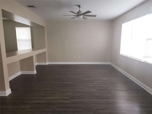 222 Bacopa Pass, Davenport, FL 33897 - spare room with a ceiling fan, dark wood finished floors, and a textured ceiling
